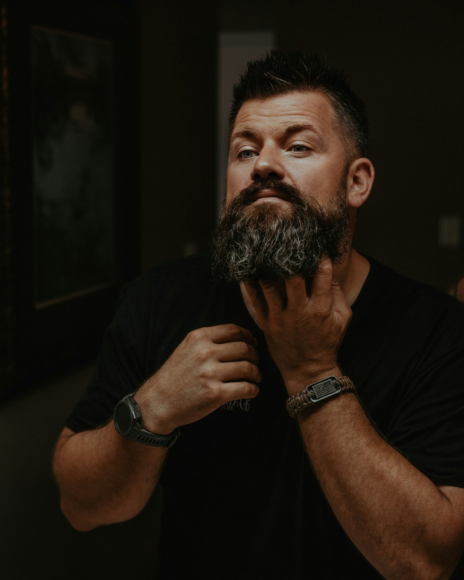 a man with a beard and a watch on his wrist